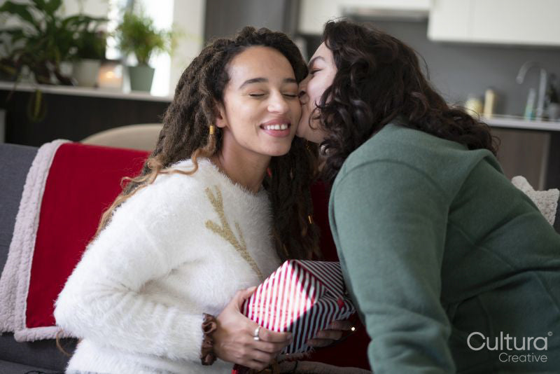 Woman giving Christmas gift to partner