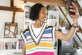 Smiling woman taking selfie at home