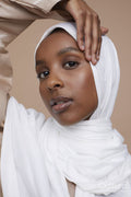 Studio portrait of young woman wearing white hijab