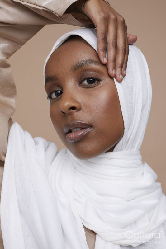 Studio portrait of young woman wearing white hijab