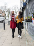 Female friends walking in town together