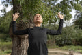 Woman practicing yoga in park