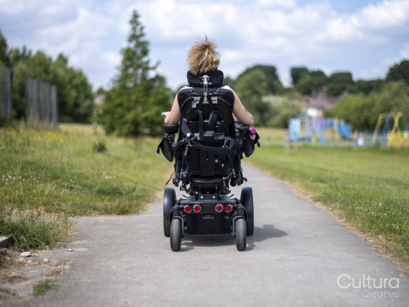 Woman in electric wheelchair going on walk
