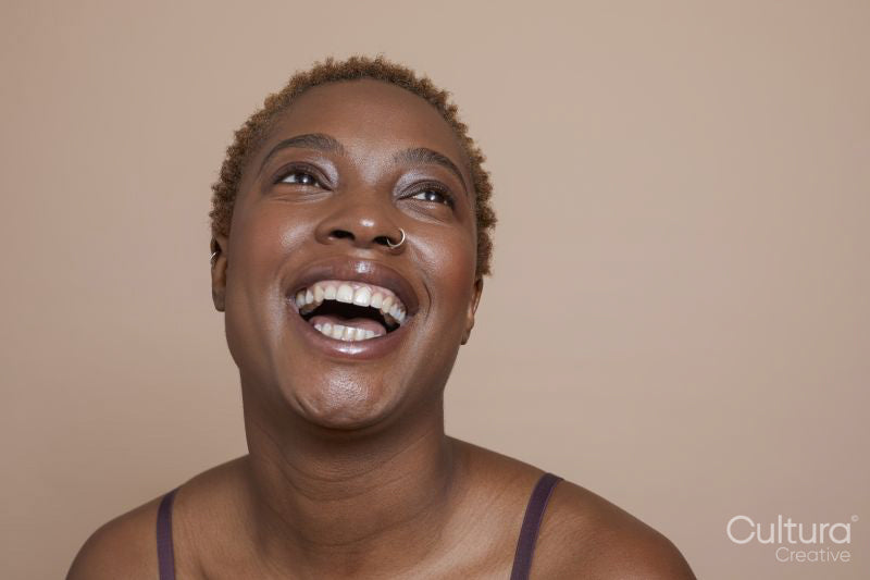 Studio portrait of smiling woman with nose ring