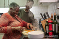 Senior couple preparing food in kitchen