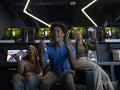Excited friends playing video games in gaming club