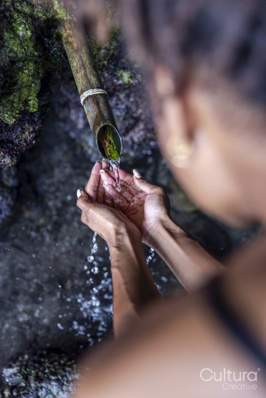 Woman taking water from drinking fountain