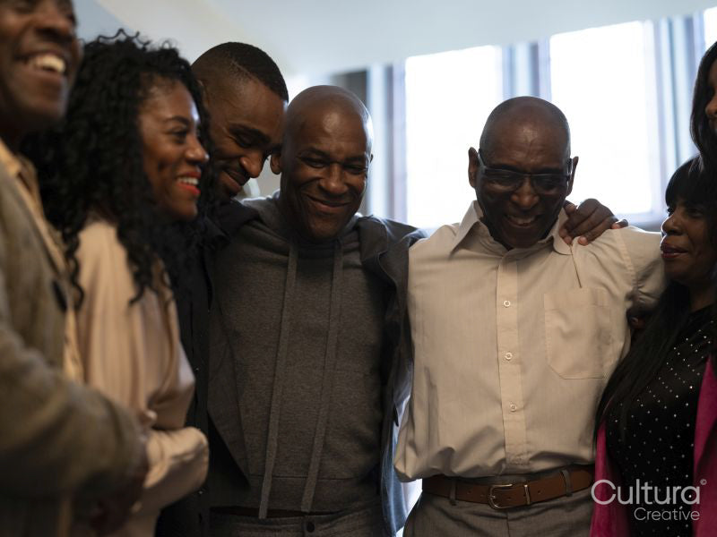 Smiling two-generation family embracing at home