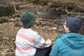 Female friends relaxing in forest by river