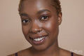 Studio portrait of smiling woman with nose ring