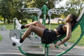 Young woman exercising in outdoor gym