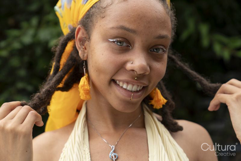 Portrait of smiling woman looking at camera in garden