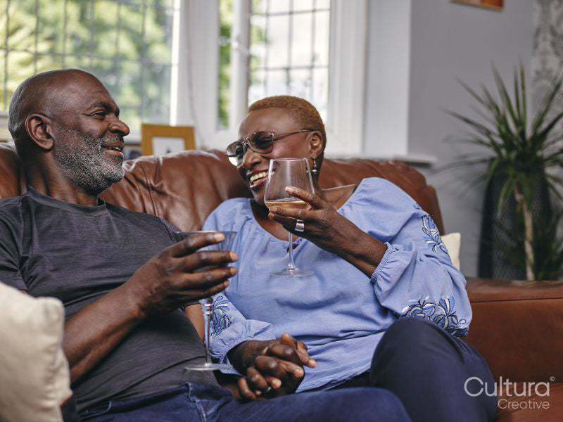 Couple sitting on sofa and drinking wine