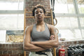 Portrait of serious woman standing with arms crossed in gym