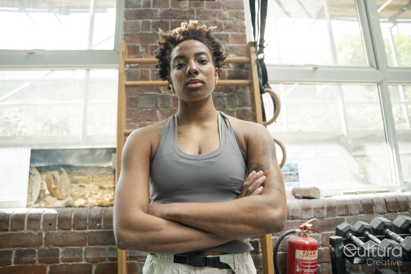 Portrait of serious woman standing with arms crossed in gym