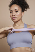 Studio portrait of athletic woman exercising with resistance band