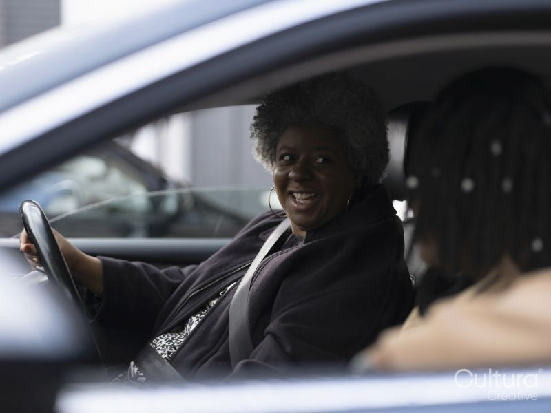 Mother and son sitting in car
