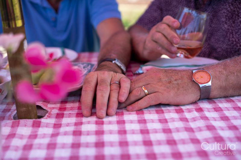 Wedding rings on senior male couple hands