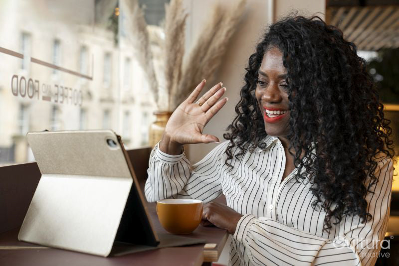 Businesswoman during video call on digital tablet in office
