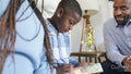 Father with children using tablet at home