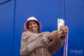 Smiling young woman taking selfie