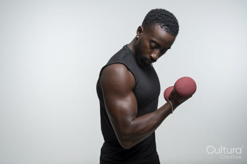 Man training arm with dumbbell