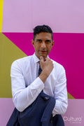 Portrait of businessman standing against colorful wall