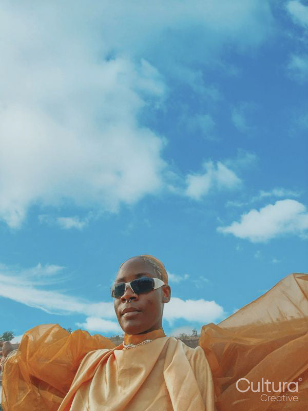 Portrait of young woman under blue sky