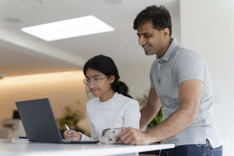 Father helping daughter doing homework