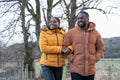 Couple in winter jackets walking in rural setting