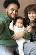 Smiling parents with baby daughter at home
