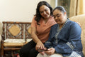 Woman with down syndrome daughter using smart phone at home