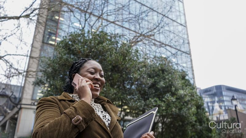 Woman using phone outside office building