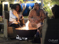 Man and woman sitting by fire pit on patio
