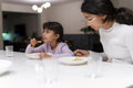 Sisters eating meal at table