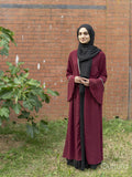 Woman wearing hijab standing in backyard