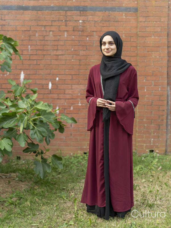 Woman wearing hijab standing in backyard