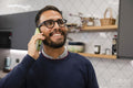 Man using smart phone in kitchen
