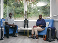 Mature couple sitting in armchairs in hotel lobby