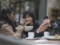 Female couple taking selfie in restaurant while eating