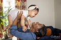 Mother playing with baby daughter at home