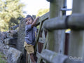 Boy climbing fence