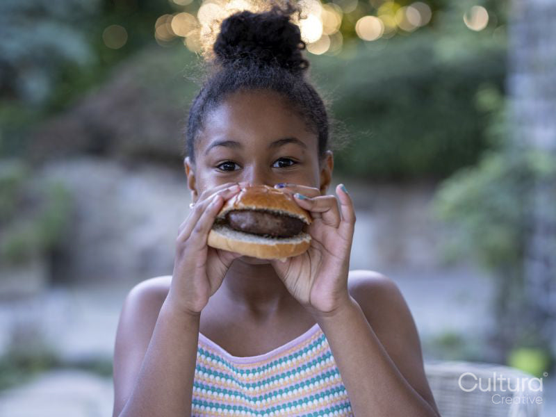 Portrait of girl eating hamburger