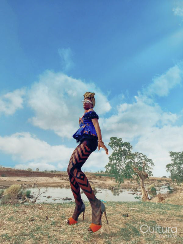 Fashion shot of young woman by river