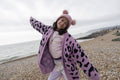 Portrait of girl standing with arms outstretched on beach