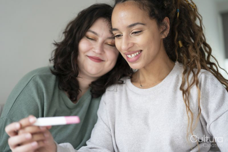 Two women checking pregnancy test