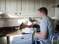 Disabled man preparing food in kitchen