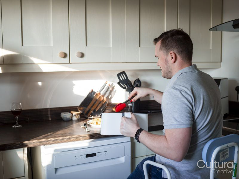 Disabled man preparing food in kitchen