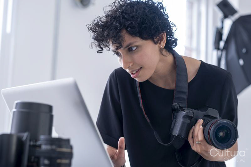 Female photographer using laptop
