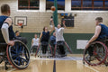 Men in wheelchairs playing basketball